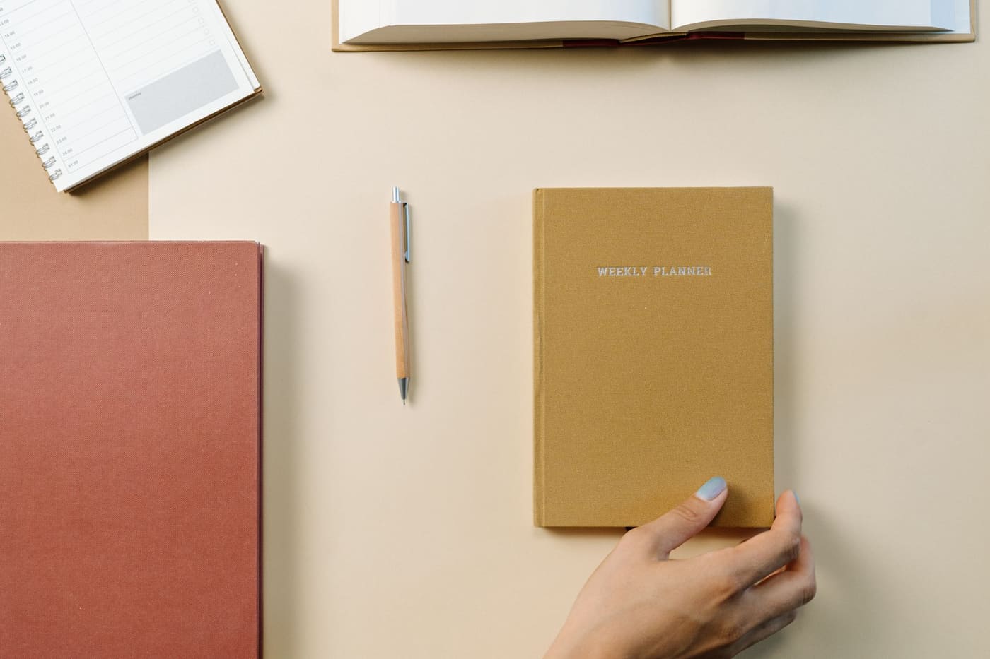 A weekly planner with a pen on a tidy desk